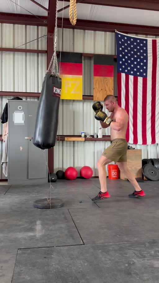 Coach Matt practicing boxing on a heavy bag